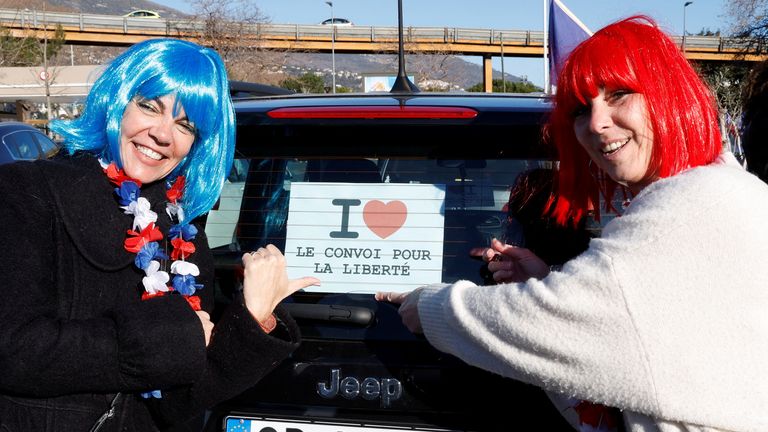 French activists show a sign reading "I love the freedom convoy" before the start of their "Convoi de la liberte" (The Freedom Convoy), a vehicular convoy protest converging on Paris to protest coronavirus disease (COVID-19) vaccine and restrictions in Nice, France, February 9, 2022. REUTERS/Eric Gaillard
