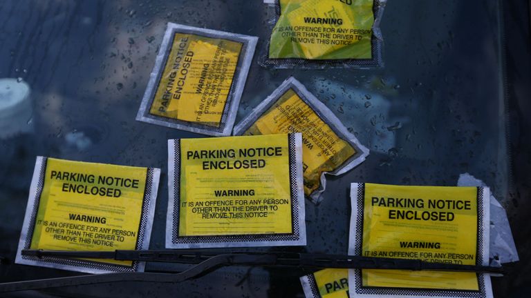 Parking Notice fixed penalties are attached to the windscreen of a Land Rover Freelander on South Carriage Drive in Hyde Park, London.