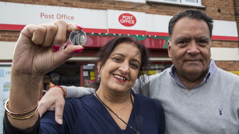Postmaster Umesh Sanghani and his wife Rashmita, who have run Dedworth Green Post Office in Windsor for 23 years with the new new 50p coin