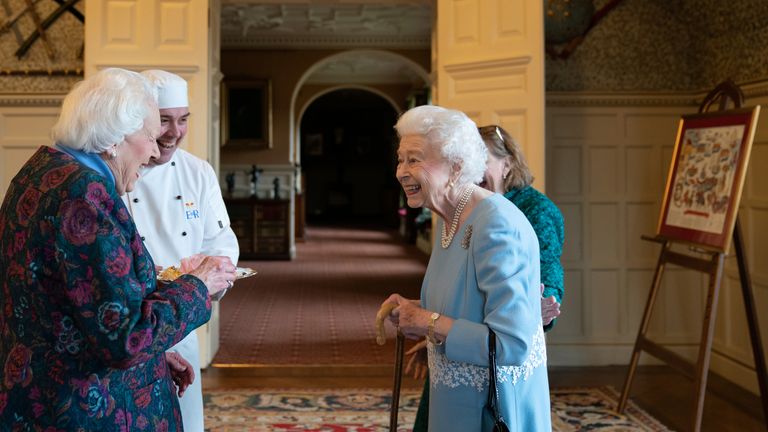 Queen Elizabeth II meets Angela Wood, the women who helped created coronation chicken, during a reception in the Ballroom of Sandringham House