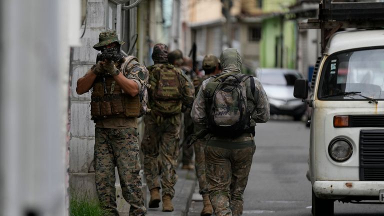 Special forces of the military police patrol during an operation against drug traffickers at the Vila Cruzeiro favela in Rio de Janeiro, Brazil, Friday, Feb. 11, 2022. (AP Photo/Silvia Izquierdo)