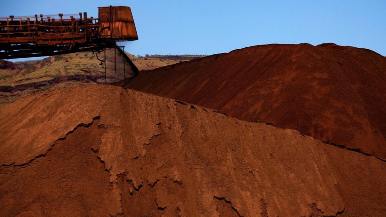 FILE PHOTO: A stacker unloads iron ore onto a pile at a mine located in the Pilbara region of Western Australia December 2, 2013