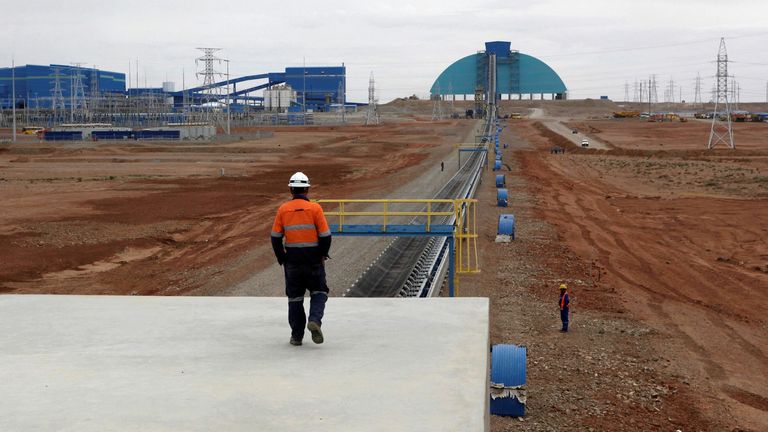 FILE PHOTO: An employee looks at the Oyu Tolgoi mine in Mongolia&#39;s South Gobi region June 23, 2012. 