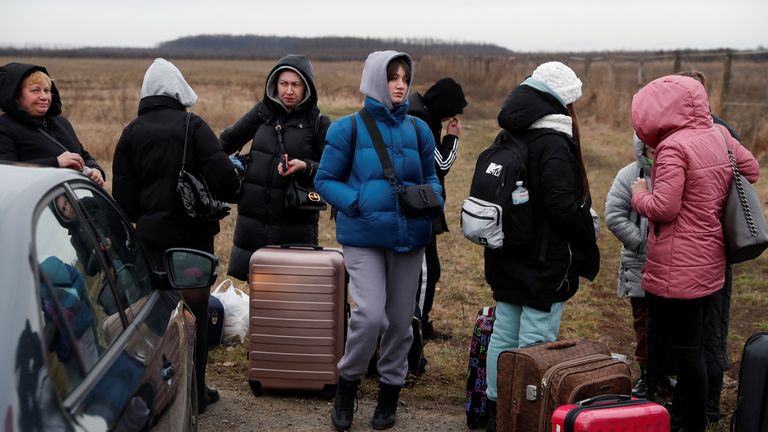 People fleeing from Ukraine arrive in Hungary, after Russia launched a massive military operation against Ukraine, at a border crossing in Beregsurany, Hungary, February 26, 2022. REUTERS/Bernadett Szabo
