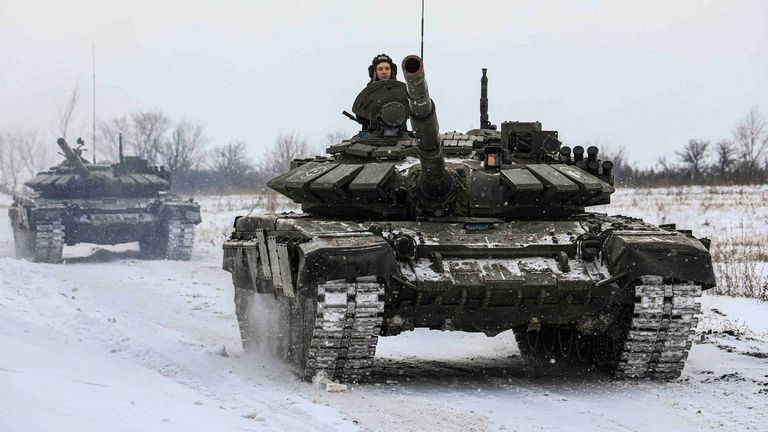 Russian servicemen drive tanks during military exercises in the Leningrad Region, Russia, in this handout picture released February 14, 2022. Russian Defence Ministry/Handout via REUTERS ATTENTION EDITORS - THIS IMAGE HAS BEEN SUPPLIED BY A THIRD PARTY. MANDATORY CREDIT. NO RESALES. NO ARCHIVES.
