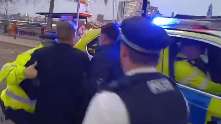 Labour leader Sir Keir Starmer is led to a police car as he is surrounded by a mob