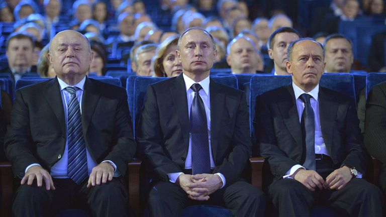 (L-R) Director of Russia's Foreign Intelligence Service (SVR) Mikhail Fradkov, President Vladimir Putin and Federal Security Service (FSB) Director Alexander Bortnikov watch a concert celebrating the Day of security service staff in Moscow, December 19, 2015. The Russian armed forces have not employed all their capability in Syria and may use "more military means" there if necessary, Russian news agencies quoted Putin as saying on Saturday. REUTERS/Alexei Druzhinin/Sputnik/Kremlin 