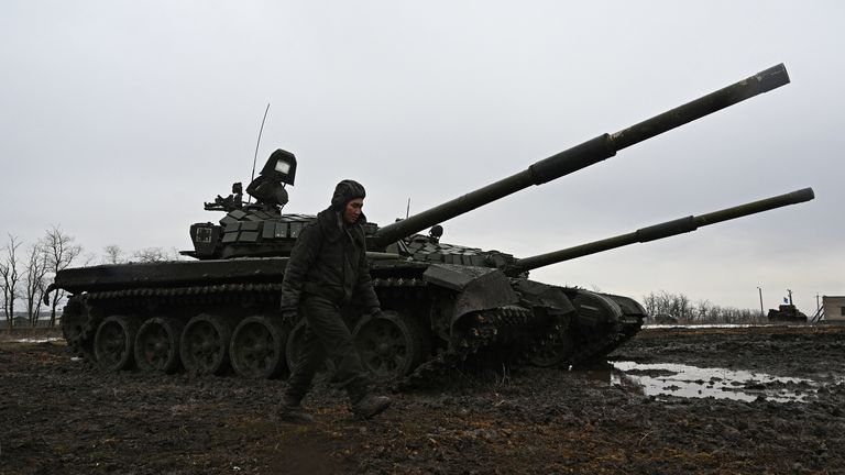A Russian service member walks past T-72B3 main battle tanks during drills held by the armed forces of the Southern Military District at the Kadamovsky range in the Rostov region, Russia February 3, 2022. REUTERS/Sergey Pivovarov
