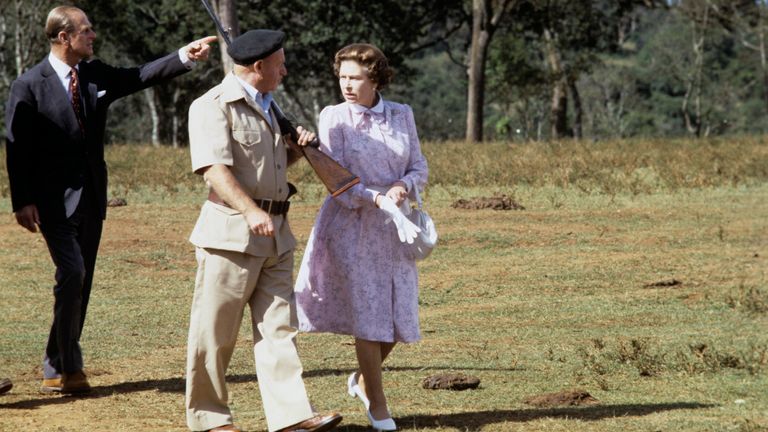 Queen Elizabeth II and the Duke of Edinburgh with Treetops guard-guide Dick Prickett at Treetops Hotel, Aberdare National Park, Kenya.