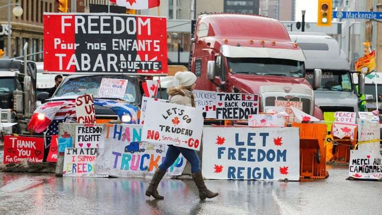 A person carries a sign as truckers and their supporters continue to protest against the coronavirus disease (COVID-19) vaccine mandates, in Ottawa, Ontario, Canada, February 10, 2022. REUTERS/Patrick Doyle
