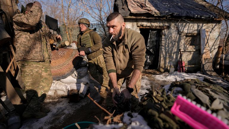 A Ukrainian serviceman washes a t-shirt at a frontline position, outside Popasna, Luhansk region, eastern Ukraine, Monday, Feb. 14, 2022. Russia&#39;s Foreign Minister Sergey Lavrov advised President Vladimir Putin on Monday to keep talking with the West on Moscow&#39;s security demands, a signal from the Kremlin that it intends to continue diplomatic efforts amid U.S. warnings of an imminent Russian invasion of Ukraine.(AP Photo/Vadim Ghirda)