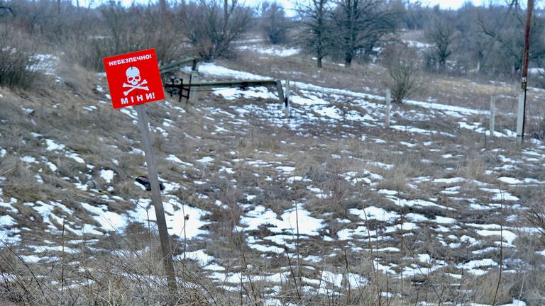 A sign warns of mines in the town near the border with Russia