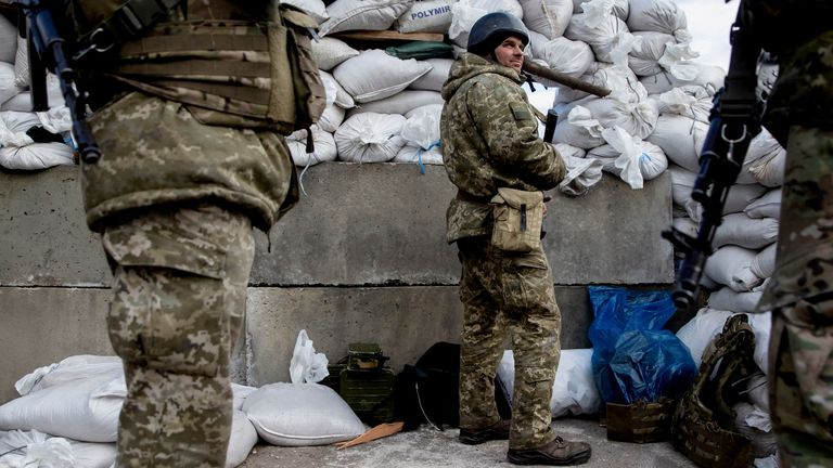 Ukrainian service members at a check point in the city of Zhytomyr, Ukraine