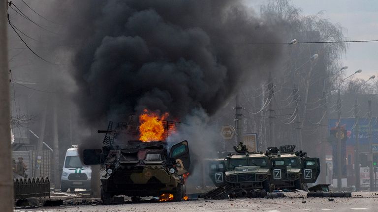 A Russian armoured personnel carrier burns amid fighting in Kharkiv, Ukraine. Pic: AP