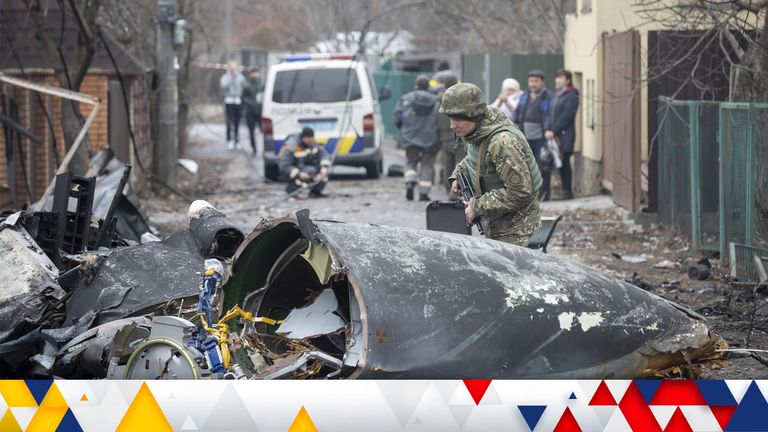A Ukrainian soldier inspects debris of a downed aircraft in Kyiv, Ukraine. Pic: AP