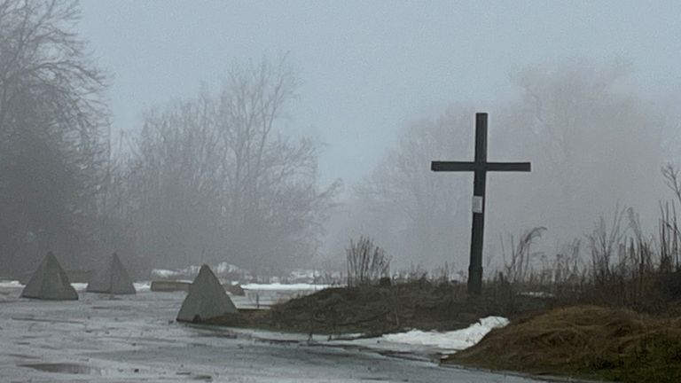 A 10-foot wooden cross overlooks the Ukrainian position near Popasne