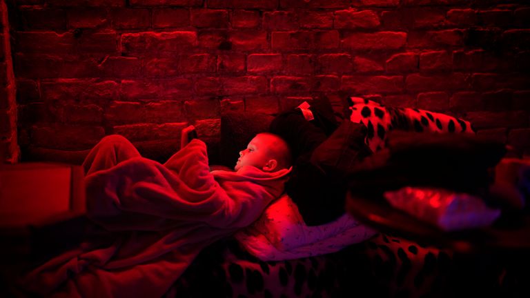 Svyatoslav, 6, plays with his tablet in a public basement used as a bomb shelter in Kyiv, Ukraine, Thursday, Feb. 24, 2022. Russia has launched a full-scale invasion of Ukraine, unleashing airstrikes on cities and military bases and sending troops and tanks from multiple directions in a move that could rewrite the world&#39;s geopolitical landscape. (AP Photo/Emilio Morenatti)


