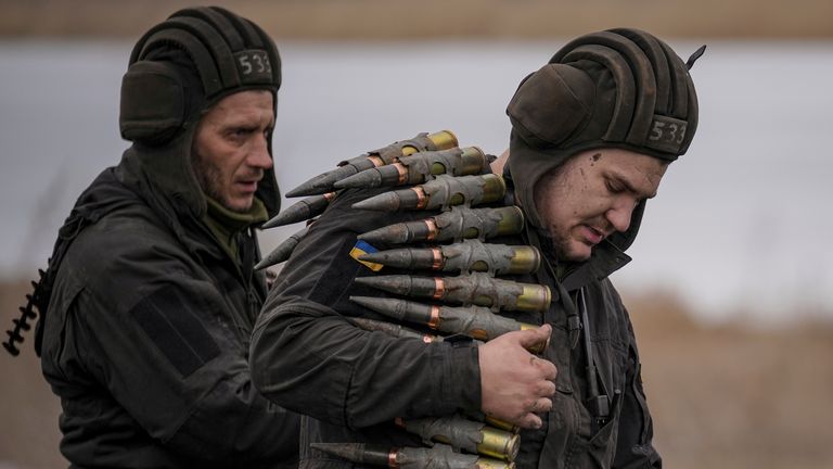 A Ukrainian serviceman carries large caliber ammunitions for armored fighting vehicles mounted weapons during an exercise in a Joint Forces Operation controlled area in the Donetsk region, eastern Ukraine. Pic: AP