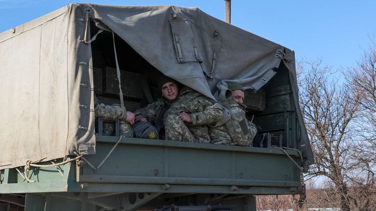Ukrainian army soldier sits in a truck, after Russian President Vladimir Putin authorised a military operation, in eastern Ukraine, in Kharkiv region, Ukraine February 24, 2022. REUTERS/Antonio Bronic