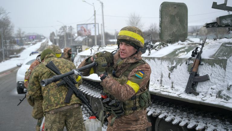 Ukrainian servicemen stand guard on a road in Kharkiv, Ukraine February 25, 2022. REUTERS/Maksim Levin
