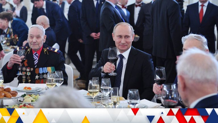 Russia&#39;s President Vladimir Putin (C) holds a glass of wine sitting with WWII veterans during the reception in honour of the Battle of Stalingrad in Moscow in this picture provided by Ria Novosti February 1, 2013. 