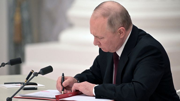 Russian President Vladimir Putin signs documents, including a decree recognising two Russian-backed breakaway regions in eastern Ukraine as independent entities, during a ceremony in Moscow, Russia, in this picture released February 21, 2022. Sputnik/Alexey Nikolsky/Kremlin via REUTERS ATTENTION EDITORS - THIS IMAGE WAS PROVIDED BY A THIRD PARTY.