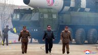 North Korean leader Kim Jong Un walks away from what state media report is a "new type" of intercontinental ballistic missile (ICBM) 