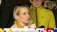 Marina Ovsyannikova, a Channel One employee who staged an on-air protest as she held up a anti-war sign behind a studio presenter, speaks to the media as the leaves the court building in Moscow, Russia March 15, 2022 in this still image taken from a video. REUTERS TV via REUTERS
