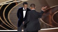Will Smith (R) hits Chris Rock as Rock spoke on stage during the 94th Academy Awards in Hollywood, Los Angeles, California, U.S., March 27, 2022. Picture taken March 27, 2022. REUTERS/Brian Snyder BEST AVAILABLE QUALITY