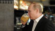 Russian Prime Minister and President-elect Vladimir Putin drinks beer during a visit to a self-service restaurant after taking part in a march to celebrate International Workers&#39; Day, or Labour Day, in Moscow May 1, 2012. REUTERS/Alexsey