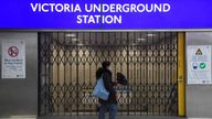 A rail passenger walks past a closed Tube station entrance in Victoria Station during the morning rush hour as the London Underground system is shut due to industrial action in London, Britain, March 1, 2022. REUTERS/Toby Melville
