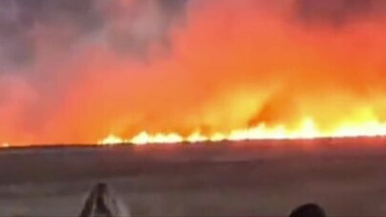 Firefighters are tackling a large fire which has broken out on Neston Marshes in the Wirral.