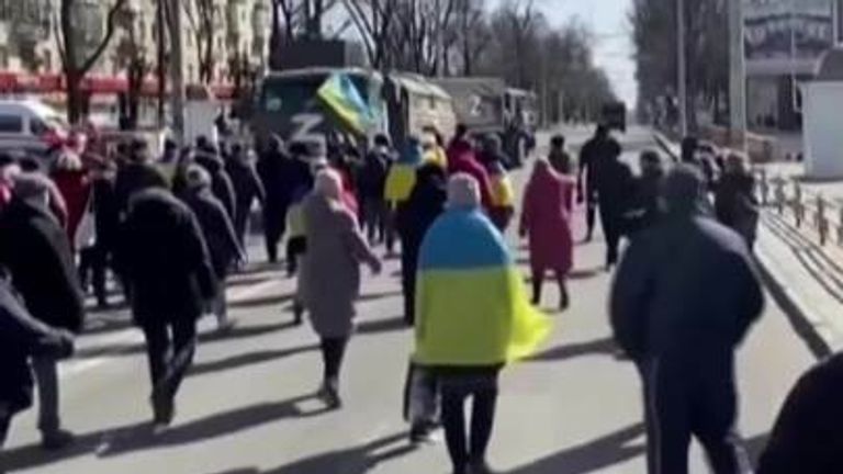 Ukrainian protesters push back Russian military vehicles.