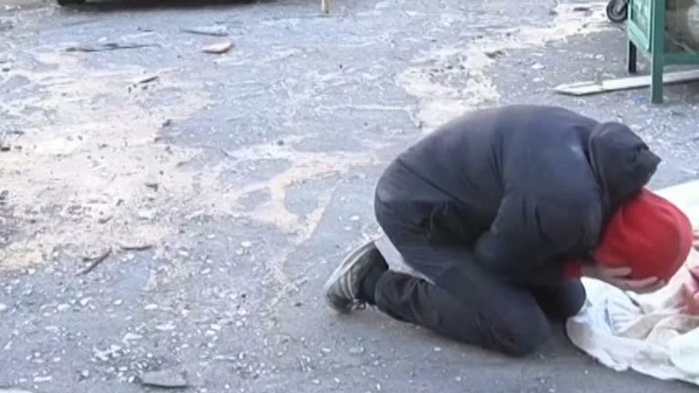 Grieving man near mother&#39;s body in Kyiv