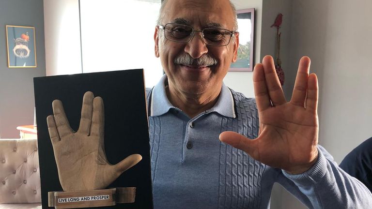 Anoosheh flashes a Vulcan salute as he poses with his Star Trek themed sculpture he made in Evin prison