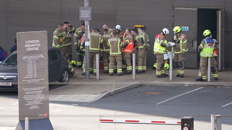 Fire officers gather outside the building