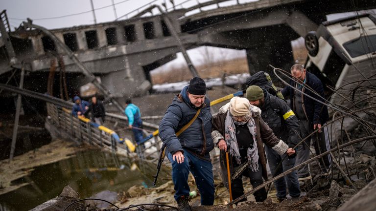 Local militiamen help an old woman crossing a bridge destroyed by artillery, as she tries to flee, on the outskirts of Kyiv, Ukraine, Wednesday, March 2. 2022. Russian forces have escalated their attacks on crowded cities in what Ukraine's leader called a blatant campaign of terror. (AP Photo/Emilio Morenatti)
PIC>:AP

