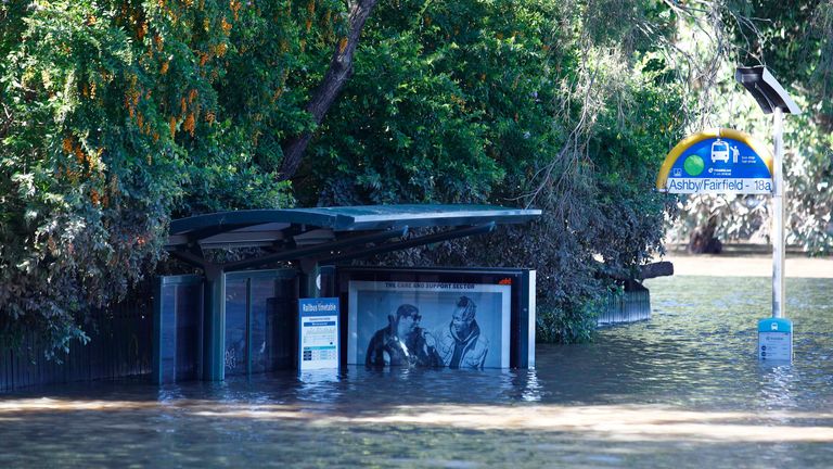 A bus shelter is submerged under water in Brisbane, Australia, Tuesday, March 1, 2022. Tens of thousands of people had been ordered to evacuate their homes and many more had been told to prepare to flee as parts of Australia...s southeast coast are inundated by the worst flooding in decades. (AP Photo/Tertius Pickard)
