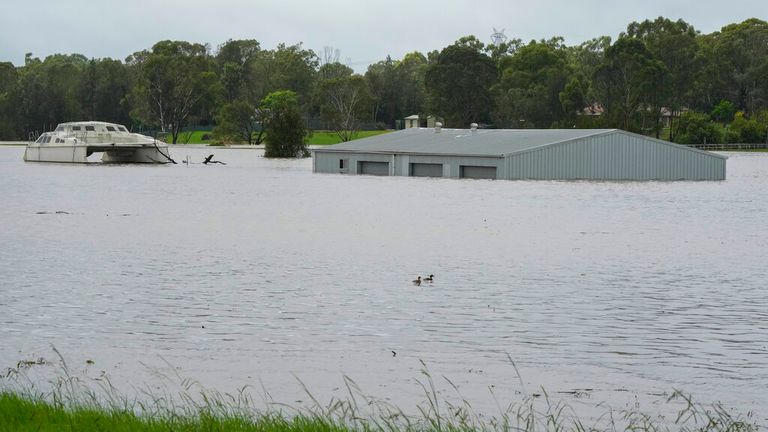 A building is submerged in flood waters near Windsor on the outskirts of Sydney, Australia, Thursday, March 3, 2022.Tens of thousands of people had been ordered to evacuate their homes and many more had been told to prepare to flee as parts of Australia&#39;s southeast coast are inundated by the worst flooding in decades. (AP Photo/Rick Rycroft)