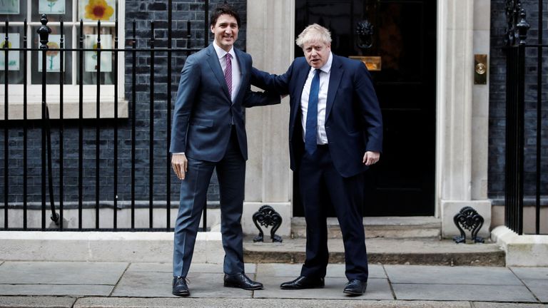 British Prime Minister Boris Johnson and Canadian Prime Minister Justin Trudeau meet outside 10 Downing Street, in London, Britain, March 7, 2022. REUTERS/Peter Nicholls
