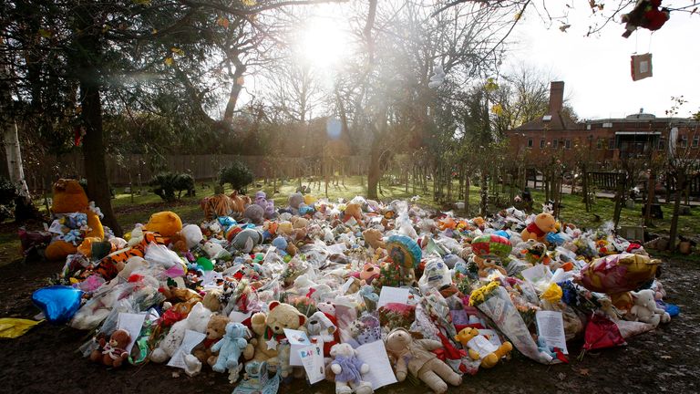 Floral tributes, photographs and toys were placed at the memorial to Baby P at Islington Crematorium on 2 December 2008