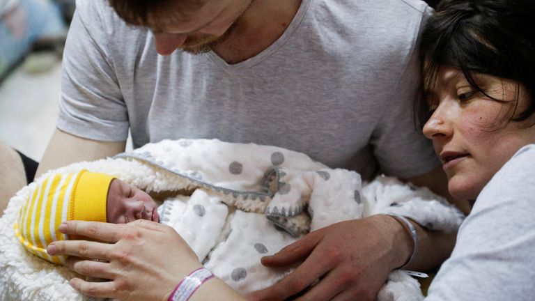 A couple with their newborn baby take shelter in the basement of a perinatal centre as air raid siren sounds are heard amid Russia&#39;s invasion of Ukraine, in Kyiv
