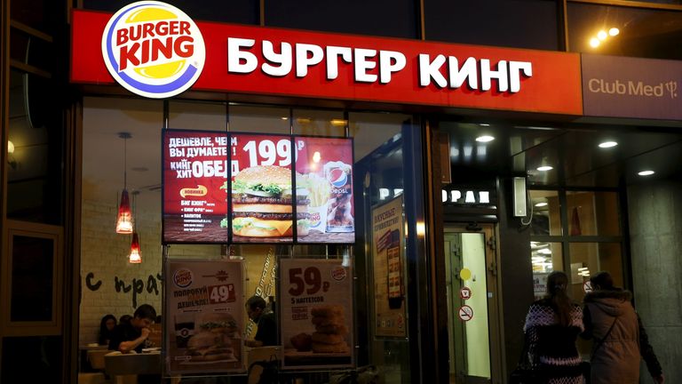 Women walk outside a Burger King restaurant in Moscow, Russia, September 15, 2015