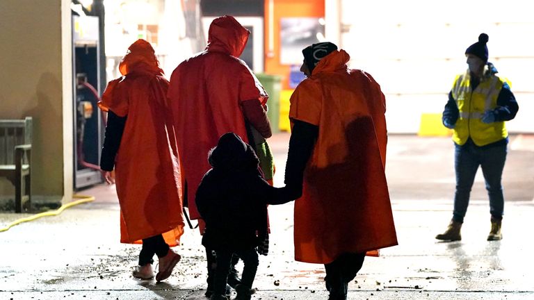A group of people thought to be migrants walk towards the lifeboat station in Dungeness, Kent, after being rescued by the lifeboat following a small boat incident in the Channel. Picture date: Saturday January 15, 2022.