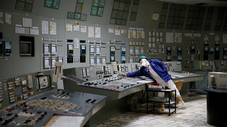 An employee is seen in a control centre of one of the stopped reactors at the Chernobyl Nuclear Power Plant in Chernobyl, Ukraine March 25, 2021. REUTERS/Gleb Garanich/File Photo