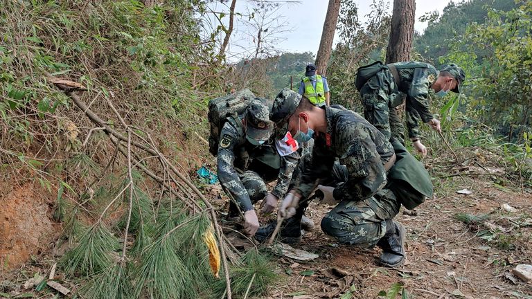 Paramilitary police officers work at the site where a China Eastern Airlines Boeing 737-800 plane flying from Kunming to Guangzhou crashed, in Wuzhou, Guangxi Zhuang Autonomous Region