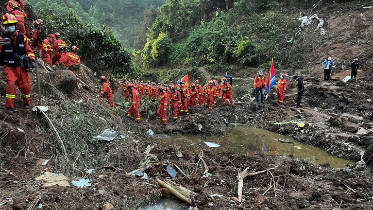 Rescuers found wallets, bank cards and identity cards covered in mud.  Photo: AP