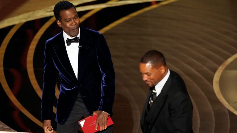 Presenter Chris Rock, left, reacts after Will Smith slapped him onstage during the 94th Academy Awards at the Dolby Theatre, Sunday, March 27, 2022, in Los Angeles. (AP Photo/Chris Pizzello)
