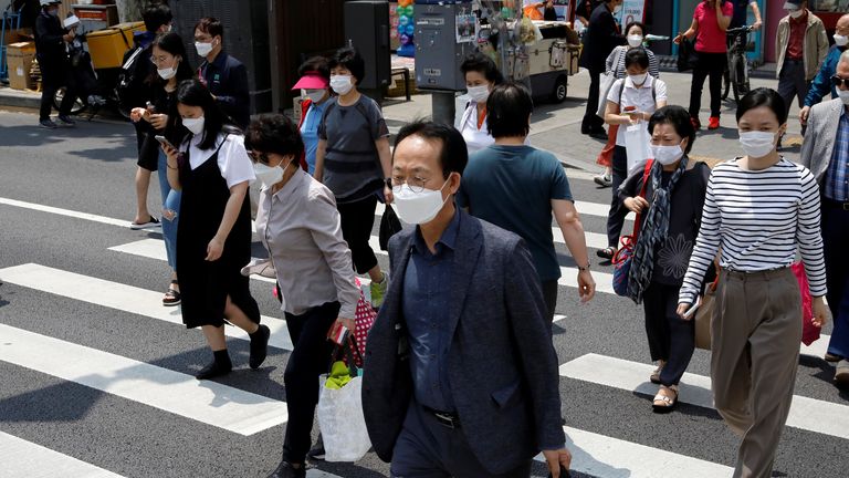 Pedestrians in face masks cross a street, amid the spread of the coronavirus disease (COVID-19), in Seoul, South Korea, May 28, 2020. REUTERS/Kim Hong-Ji