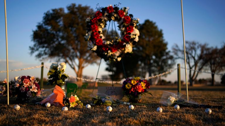 Golf balls adorn a makeshift memorial at the Rockwind Community Links Wednesday, March 16, 2022, in Hobbs, New Mexico. The memorial was for student golfers and the coach of University of the Southwest  killed in a crash in Texas. (AP Photo/John Locher)